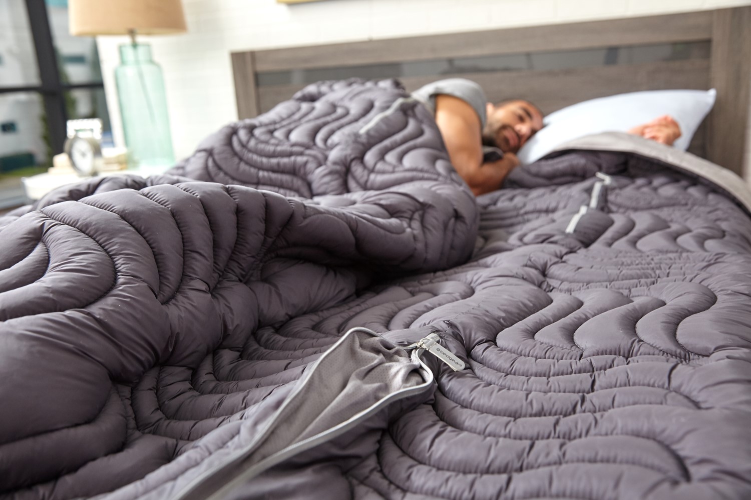 man sleeping on bed with bedgear blankets