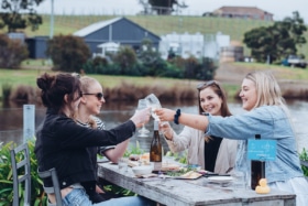 young people drinking wine at puddleduck vineyard