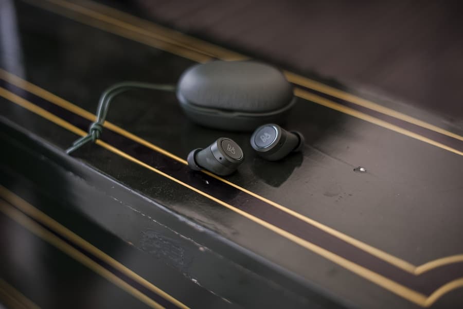 bang and olufsen's beoplay e8 earbuds on table