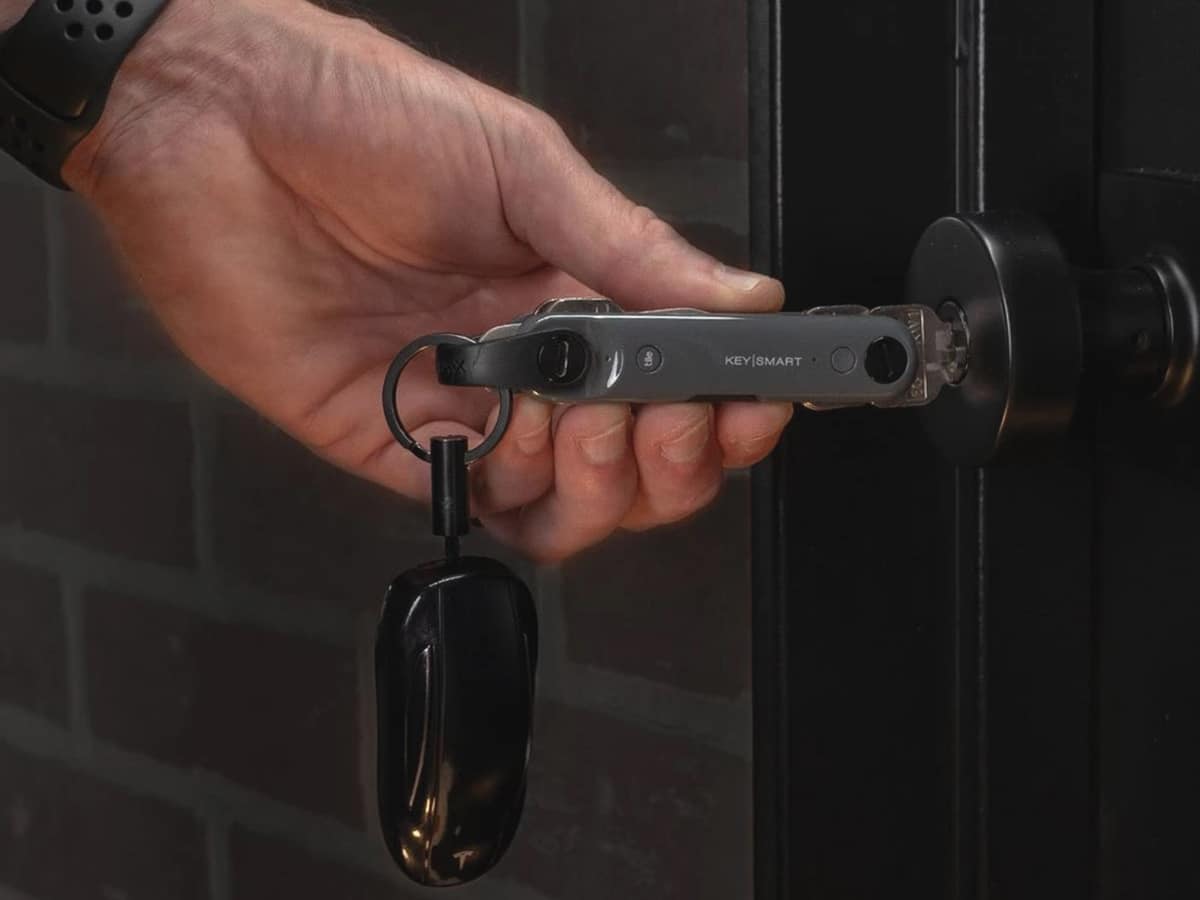 man opening a door with keysmart max with built in tile tracker