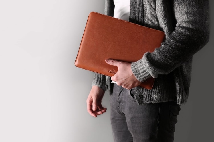 slim leather macbook sleeve case on hand