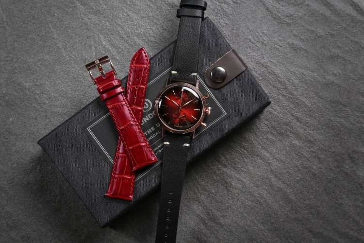 undone wrist watch with black and red belt
