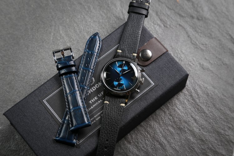 undone wrist watch with black and blue belt