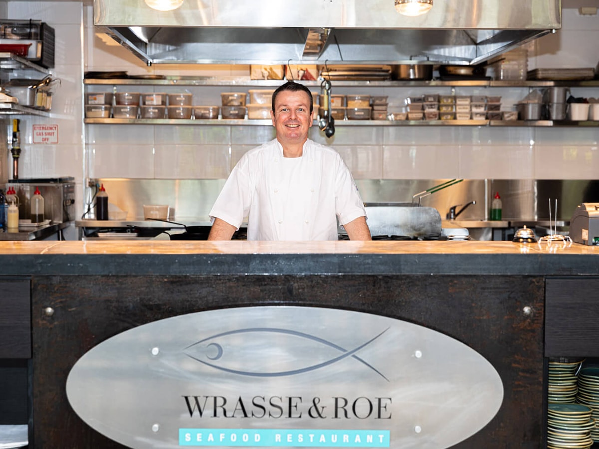 smiling chef at the wrasse roe seafood restaurant