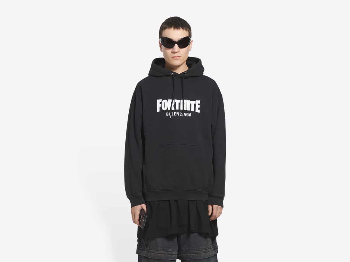 Model wearing black Fortnite x Balenciaga hoodie with sunglasses against a white background.