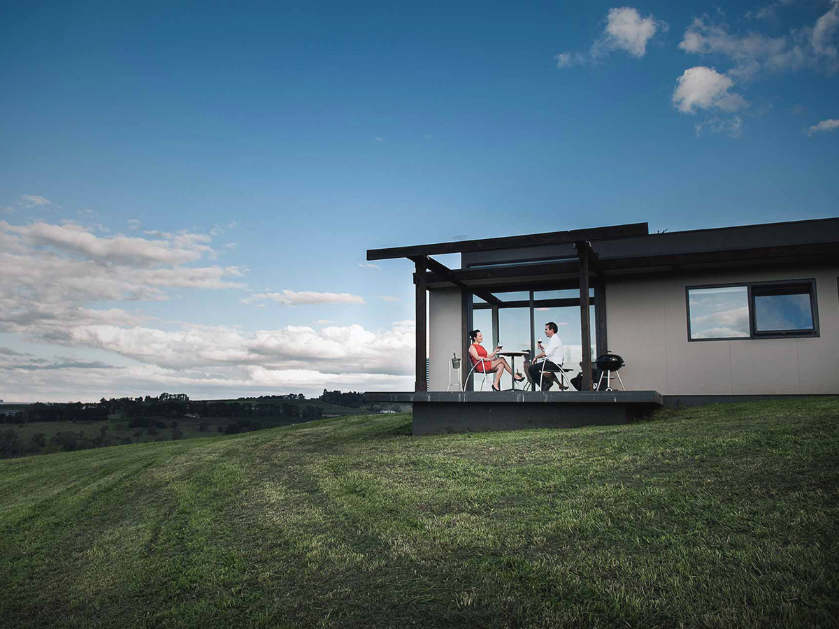 couple sitting on borrodell estate vineyard terrace