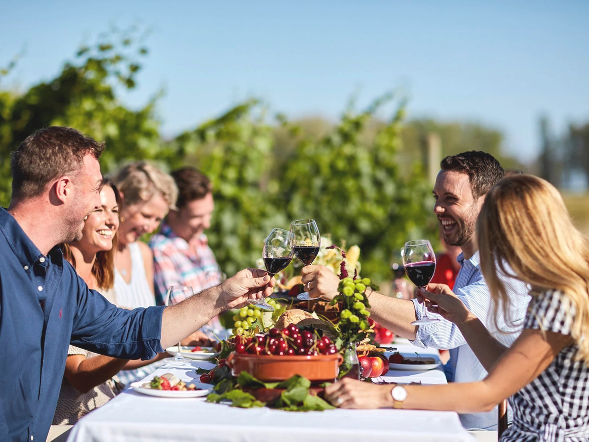 group of people drinking wine in small acres cyder vineyard