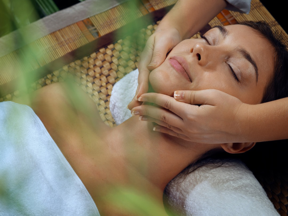 woman getting face massage at eloura lifestyle salon spa