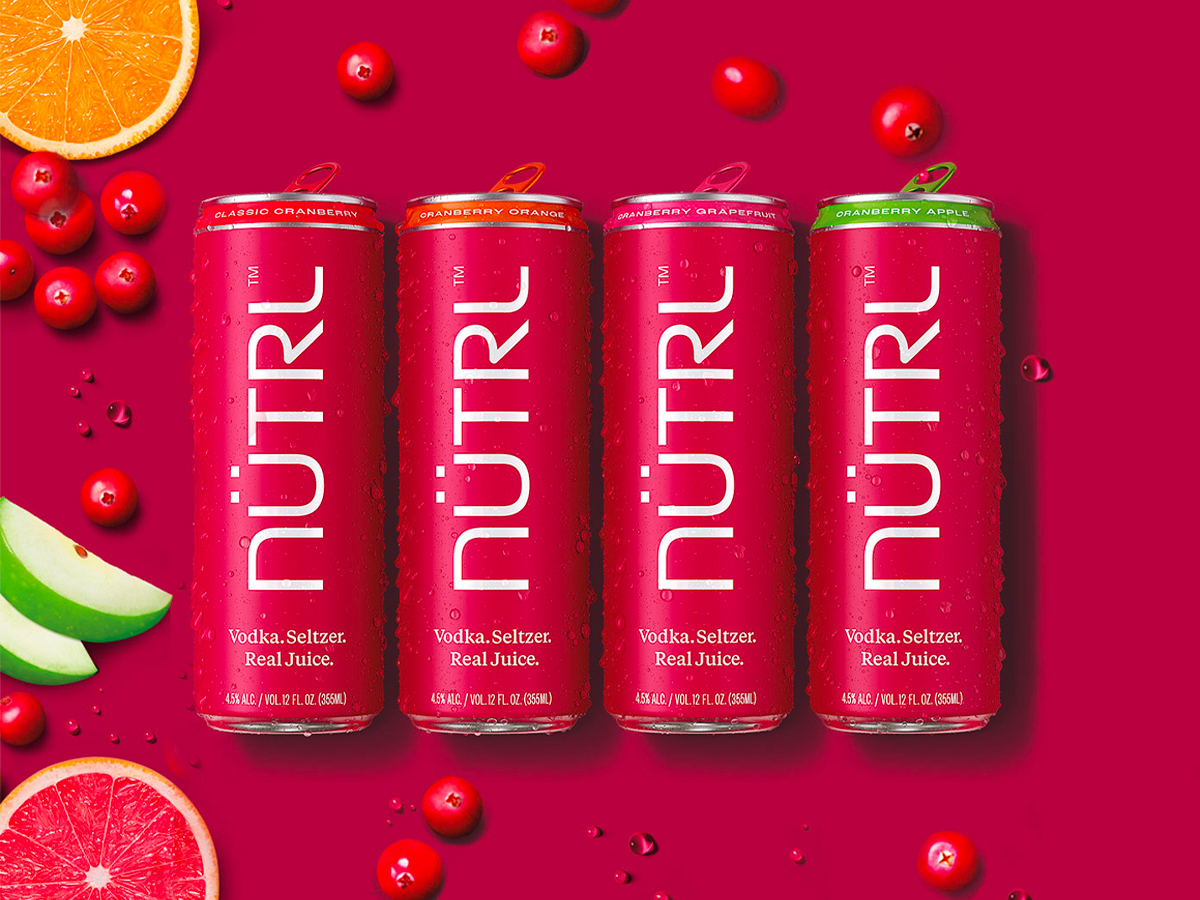 Product image of NÜTRL Vodka Seltzer Cranberry Pack with pink background and edited fruits