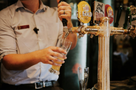 Bartender filling a glass from tap
