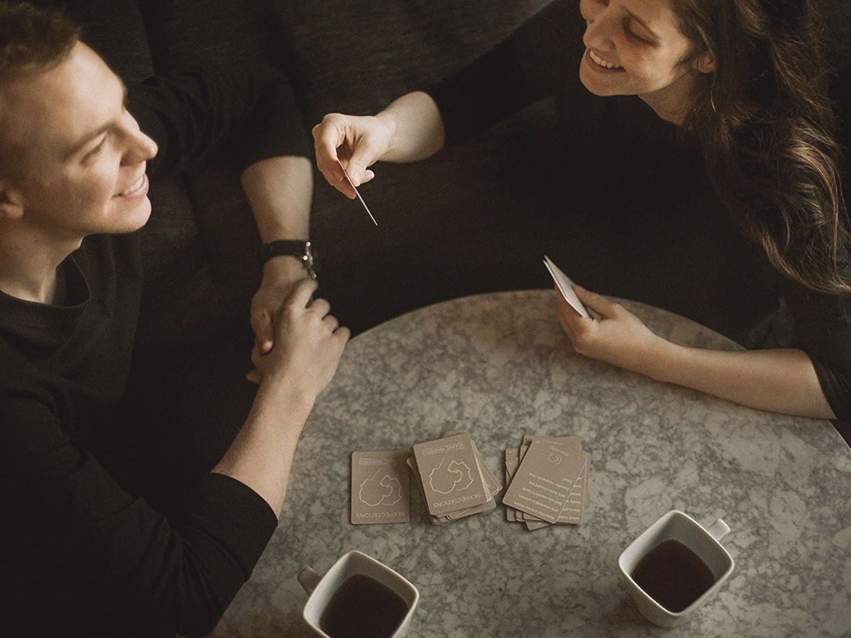 young couple playing sexpectations card game