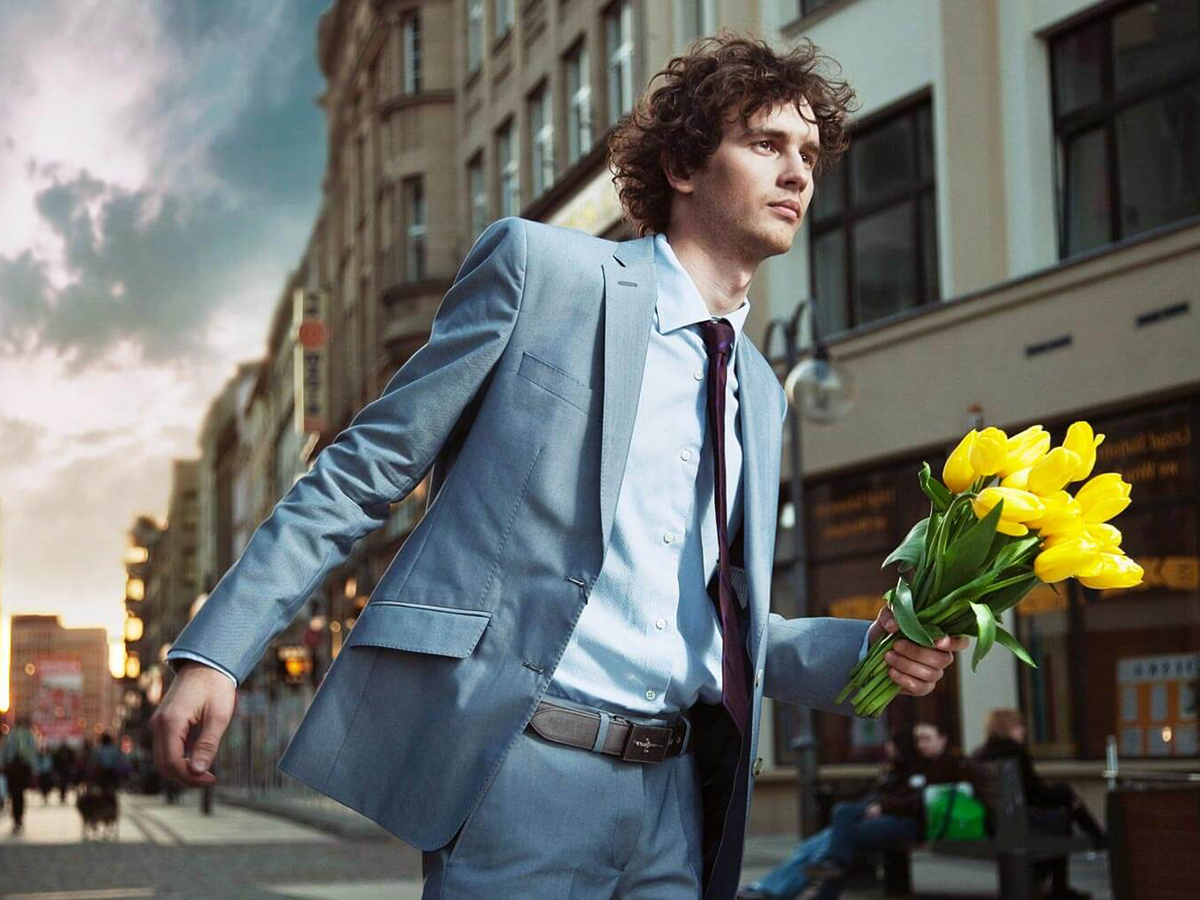 young man running with a bunch of flowers