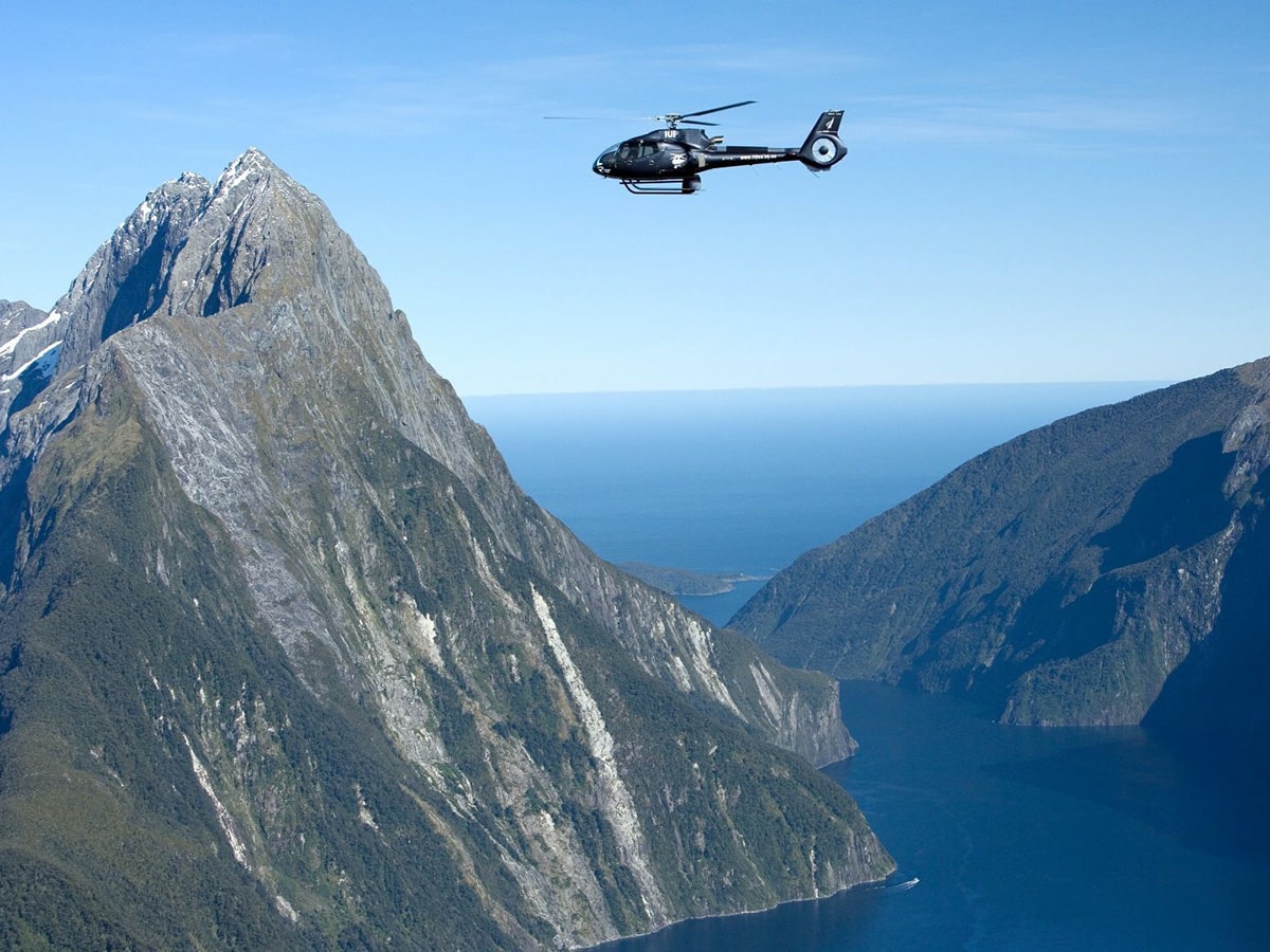 Helicopter flying over Milford Sound