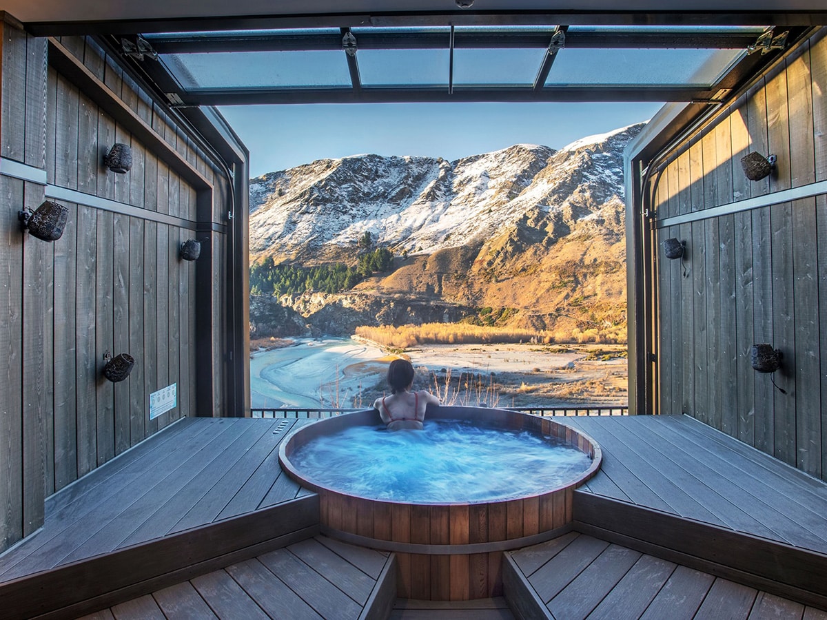 Woman relaxing in the Onsen Hot Pools overlooking the Shotover River