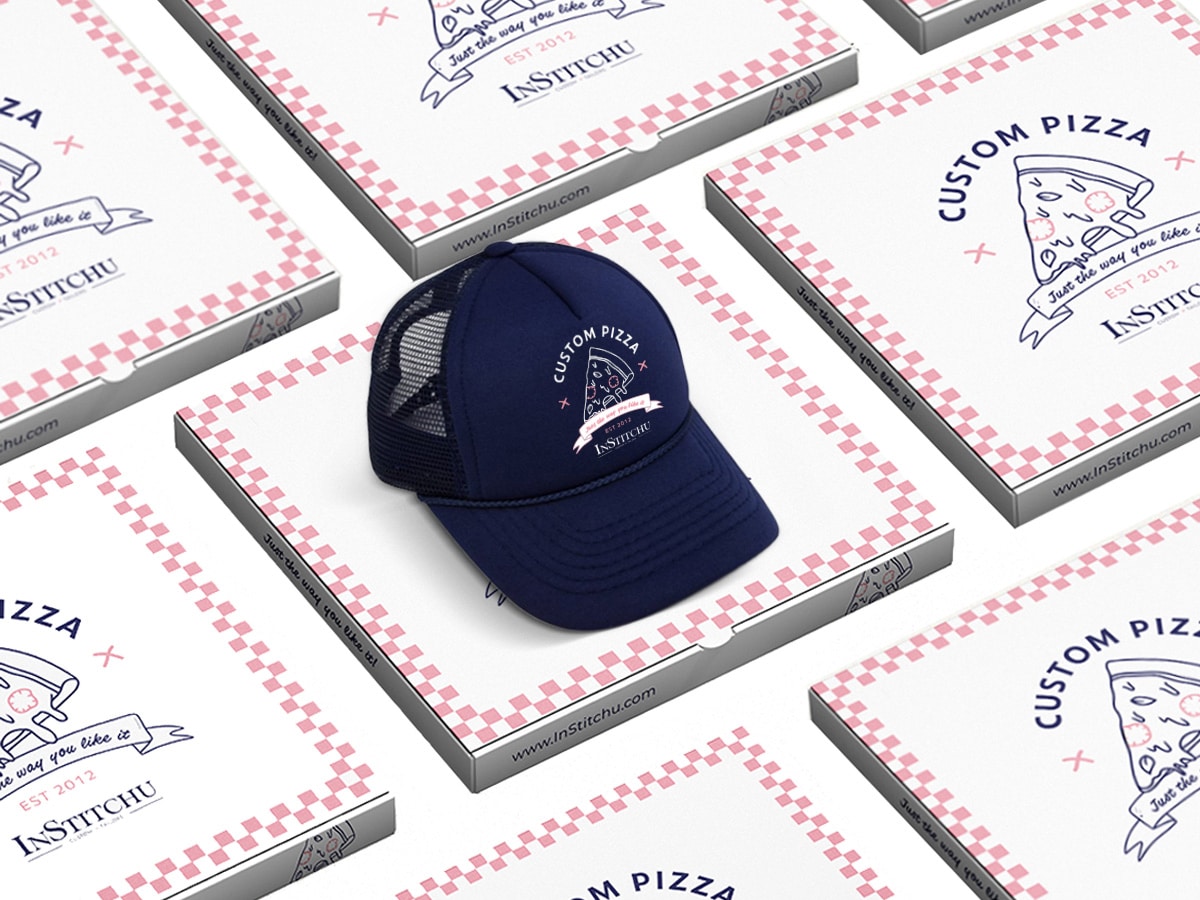 Blue cap with 'Custom Pizzeria' logo set on top of 'Custom Pizzeria' pizza boxes