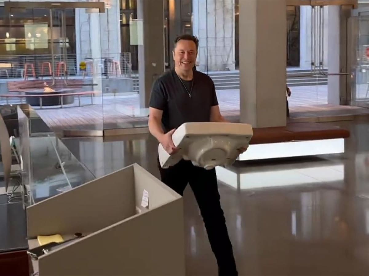 Elon musk walking into tesla