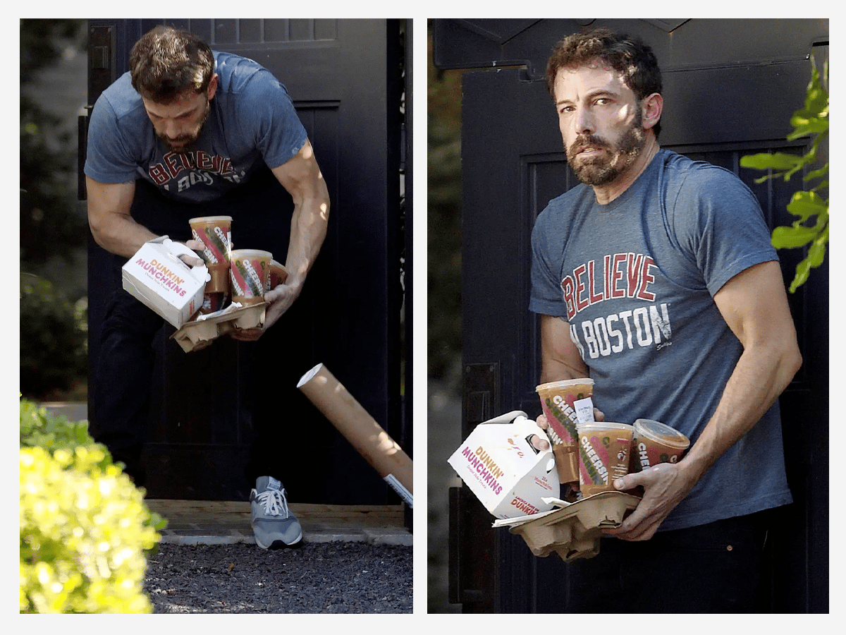 Ben Affleck attempting to pick up parcels while holding a Dunkin' Donuts coffee