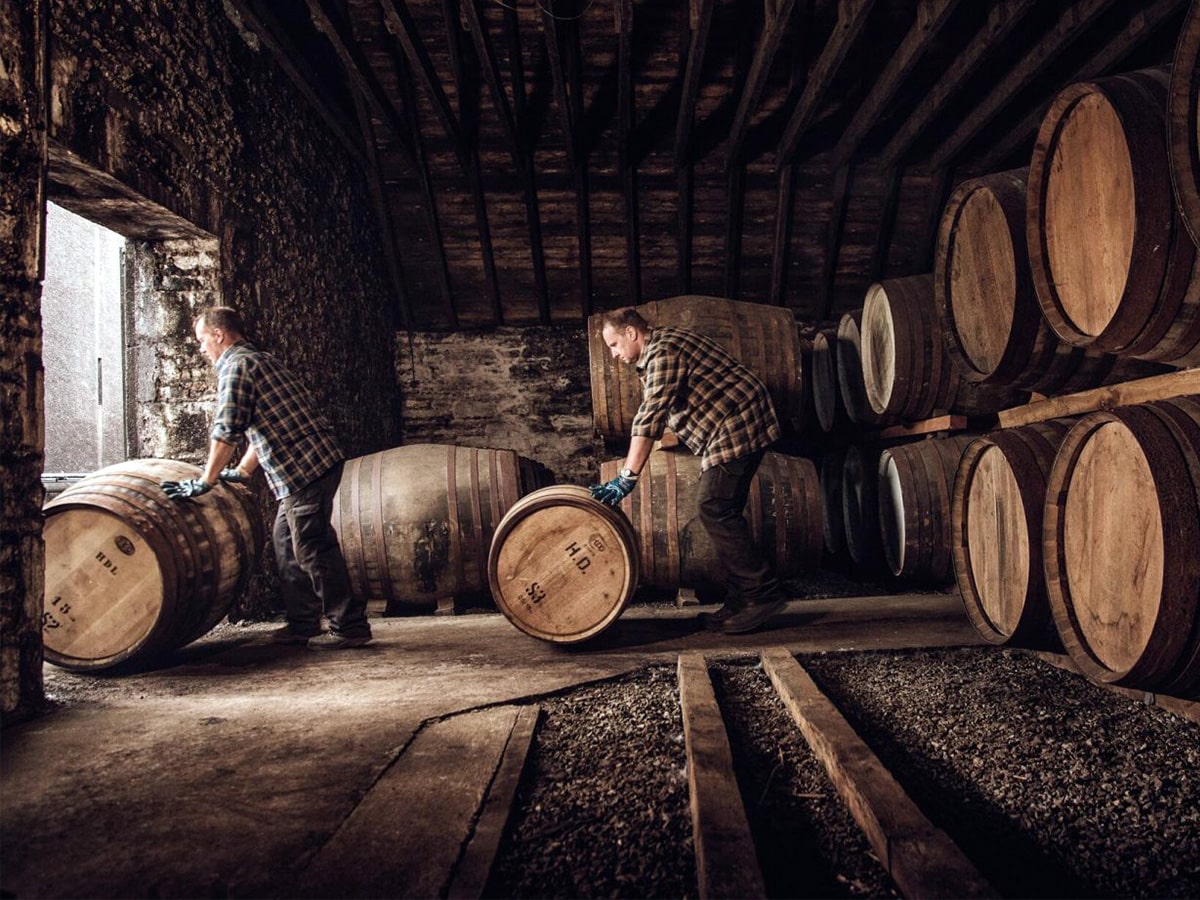 Workers in the barrel room of a distillery in Scotland | Image: Unsplash