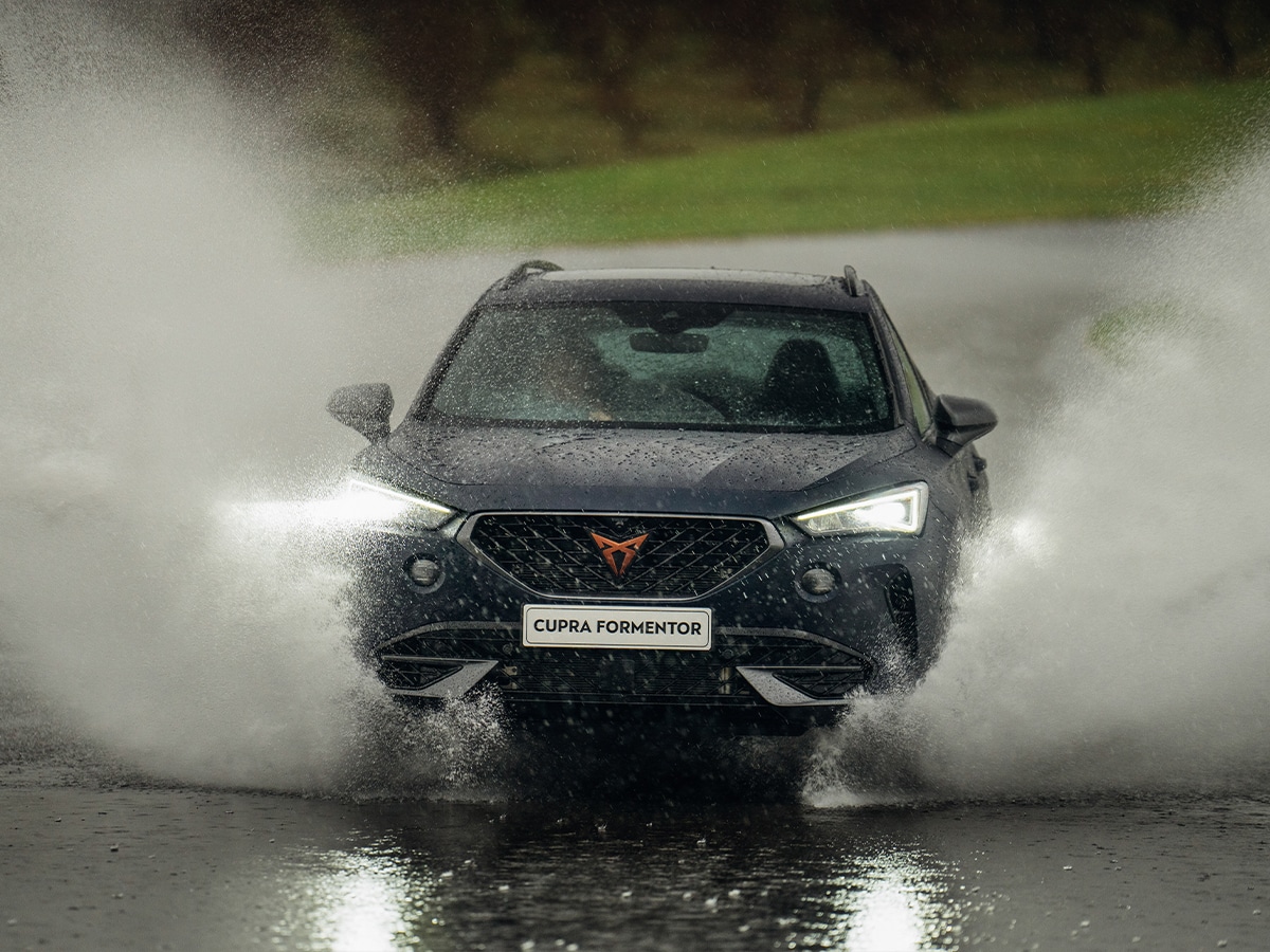 2023 cupra formentor vzx splashing through a puddle