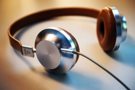 Close up of beige and silver coloured headphones