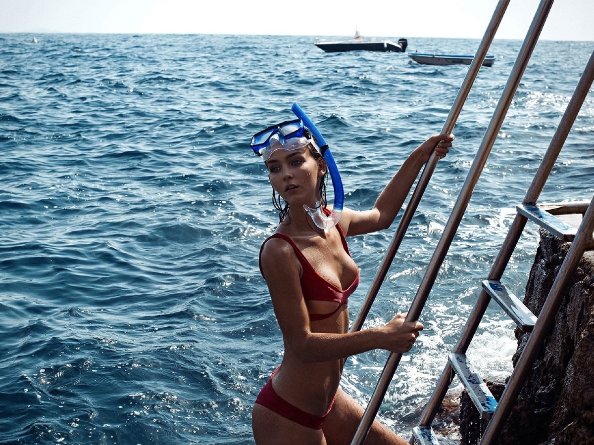 Rachel Cook in red bikini climbing ladder out of sea