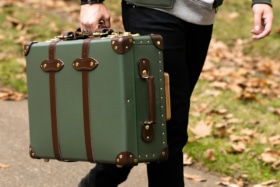 Man carrying Globe-Trotter luggage