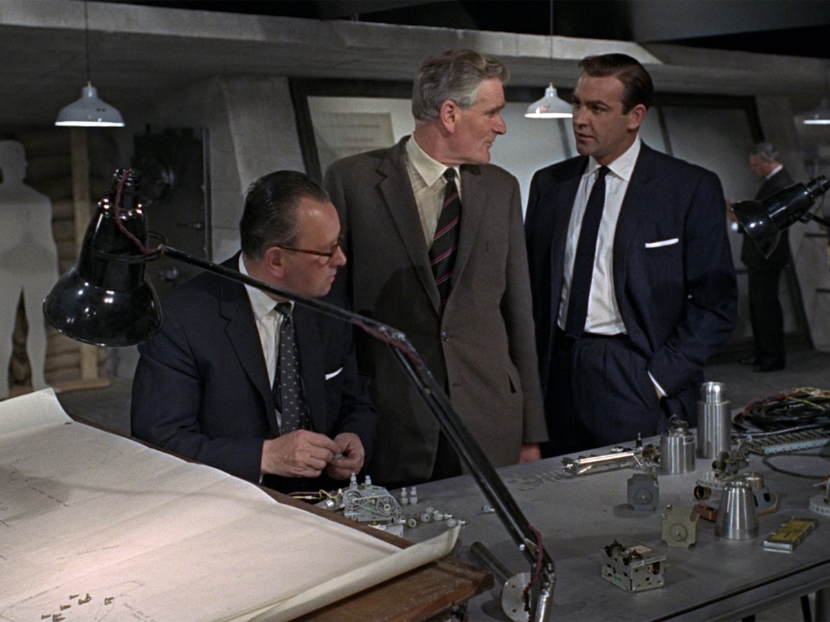 Actors in front of a table from False Fingerprints scene in Diamonds are Forever