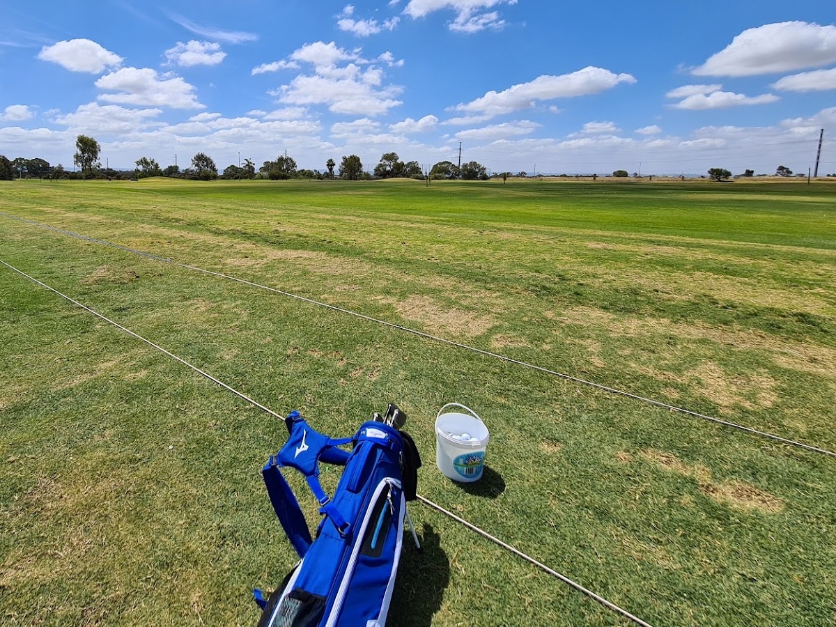 Longshot of a staff bag and a bucket of golf balls at the Melville Golf Centre