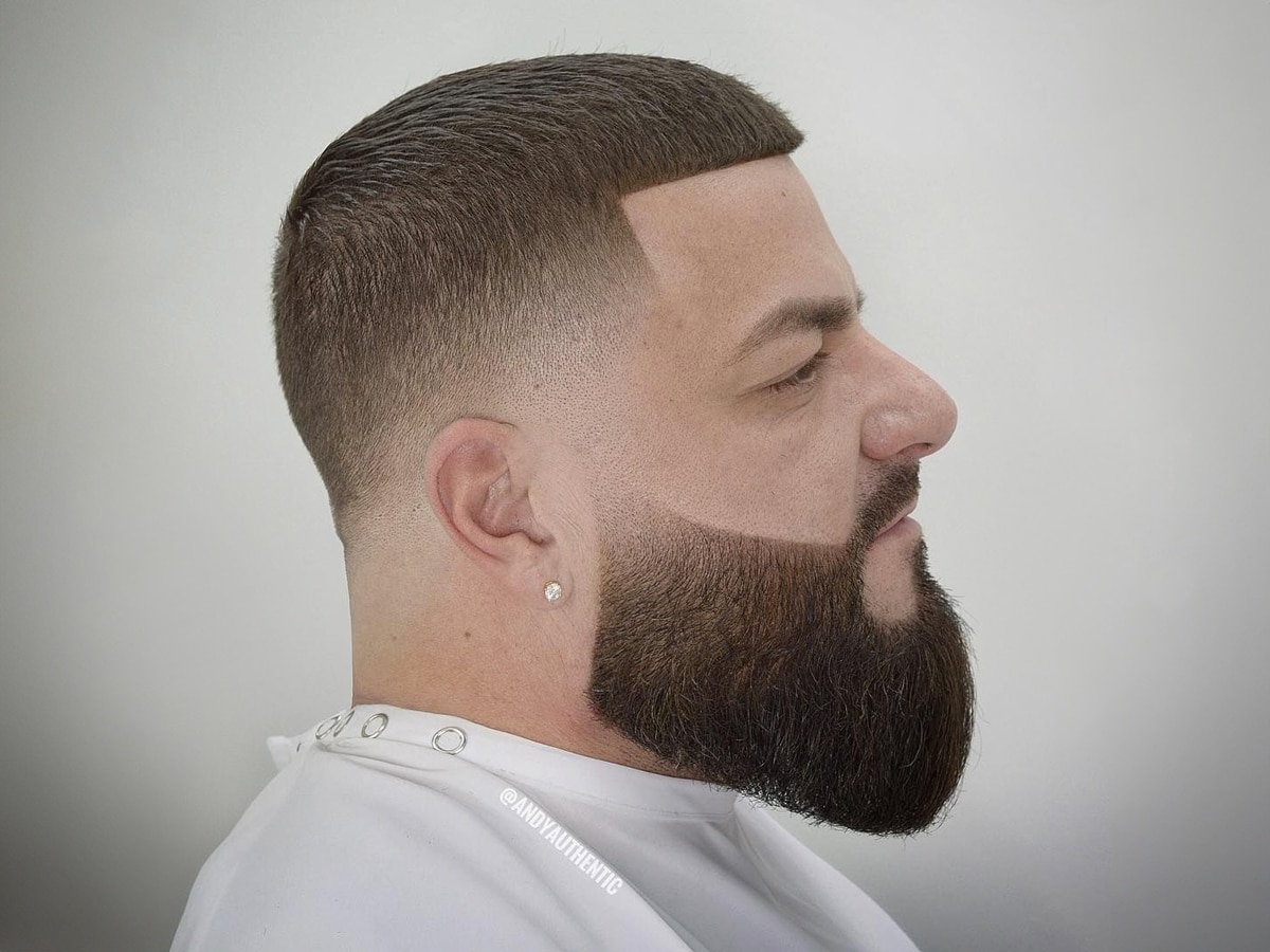 Close up side view of a man with Low Skin Fade buzz cut