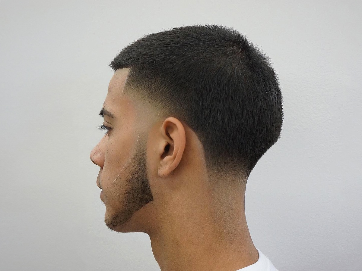 Close up side view of a man with a tapered buzz cut