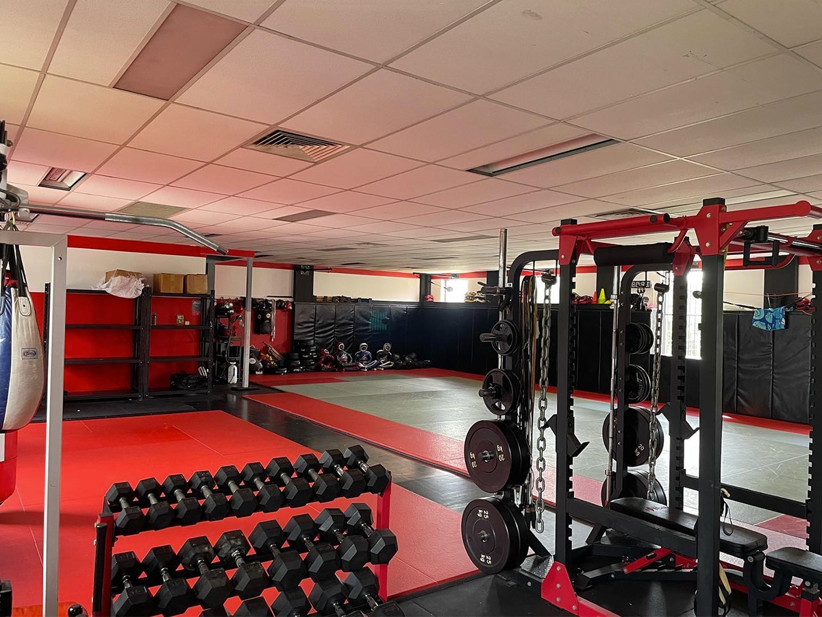 Black and red theme interior view of Power Core MMA Gym and equipment