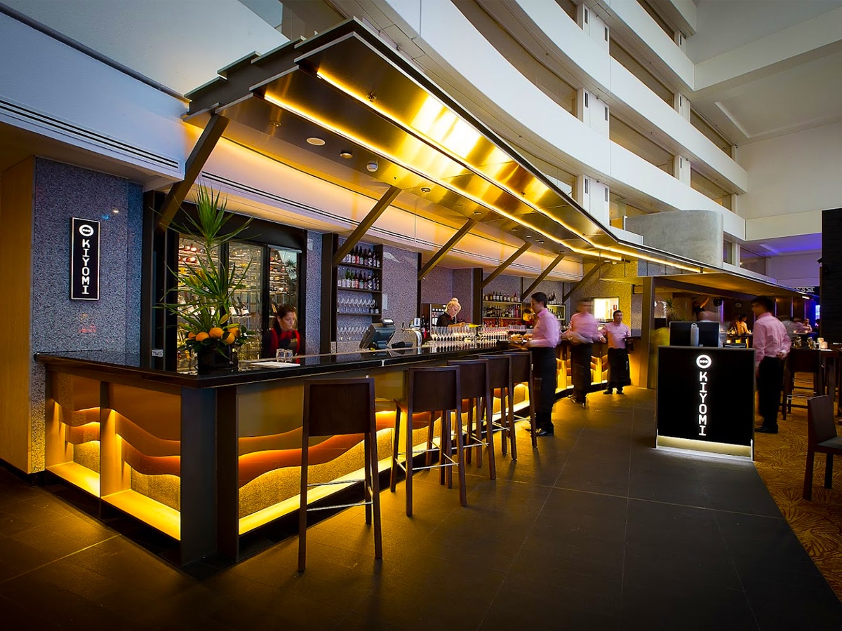 Interior of Kiyomi featuring a spacious bar with a long counter and elegant lighting