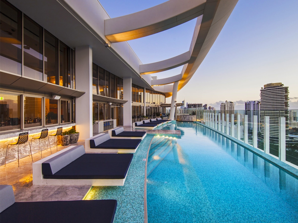 A luxurious rooftop pool with crystal-clear water surrounded by lounge chairs at Nineteen at The Star