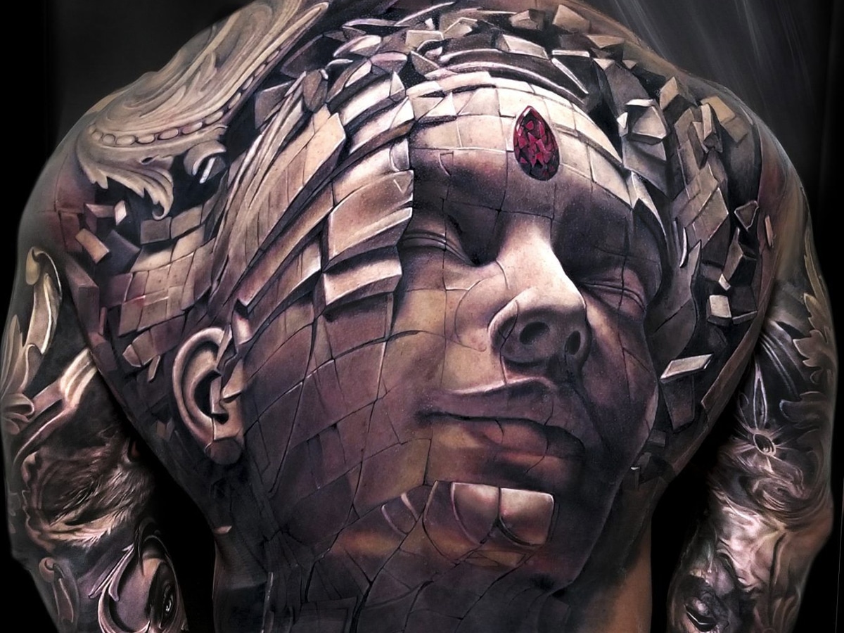 Big coloured 3D tattoo of a diced human face on a man's back