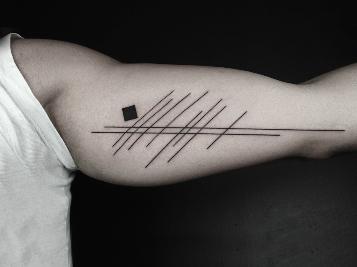 Solid black line design tattoo on a man's arm