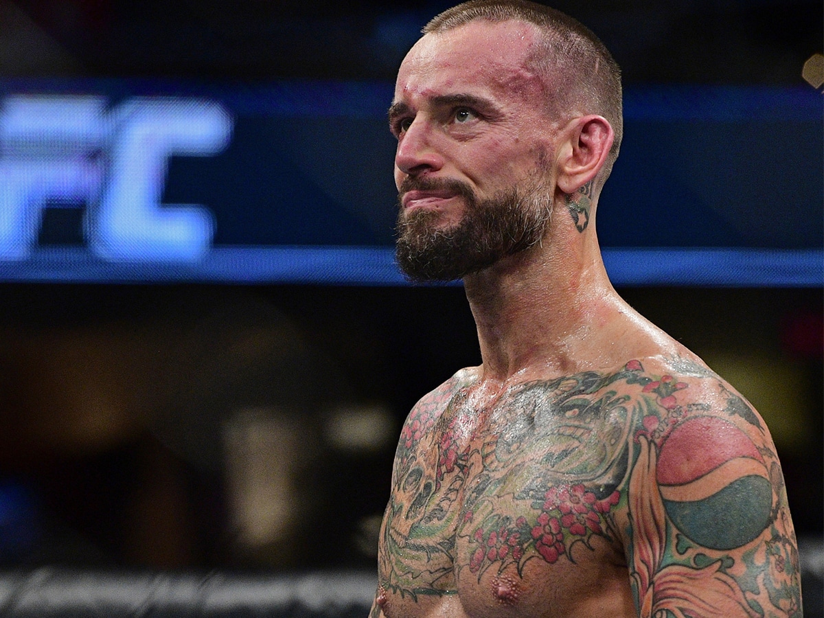 Close up of CM Punk showing his tattoos focused on the Pepsi logo design