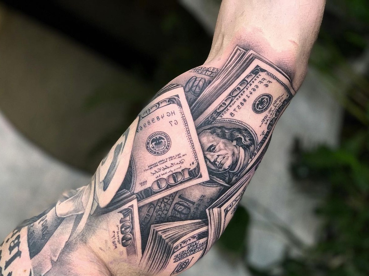 Black and gray tattoo of one hundred US dollar bill design