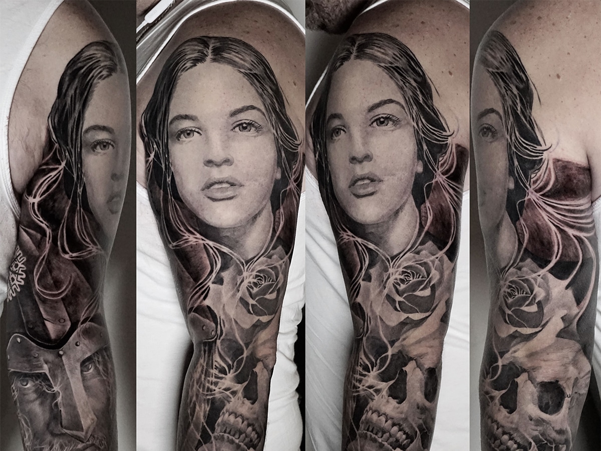 Black and gray tattoo sleeve of a stylized woman's portrait on a man's arm