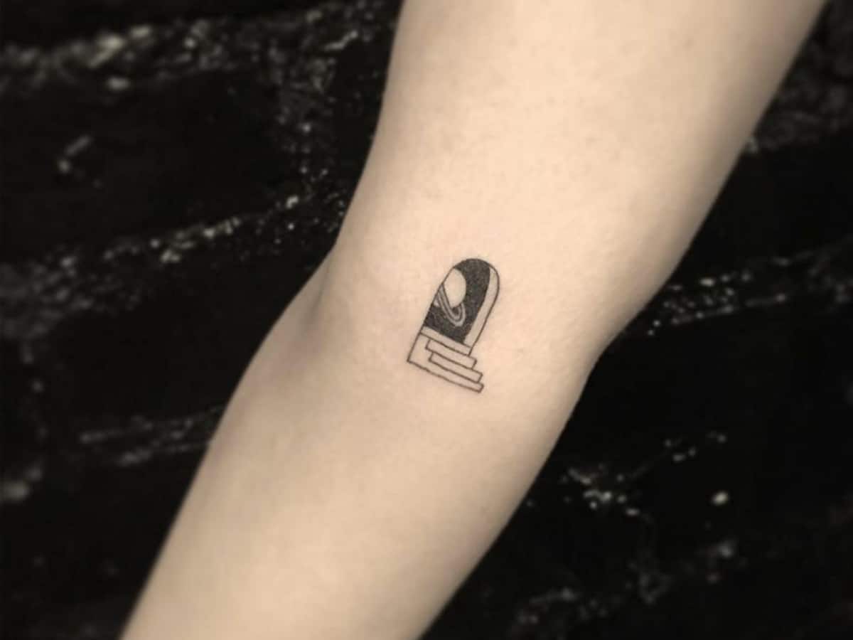 Small black and gray tattoo of open door with stairs to Jupiter