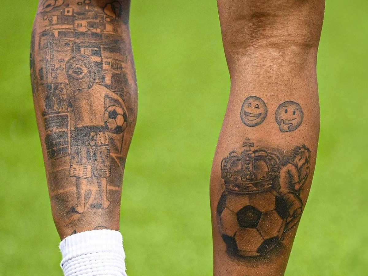 Black and gray football themed tattoo design on the back of Neymar's legs