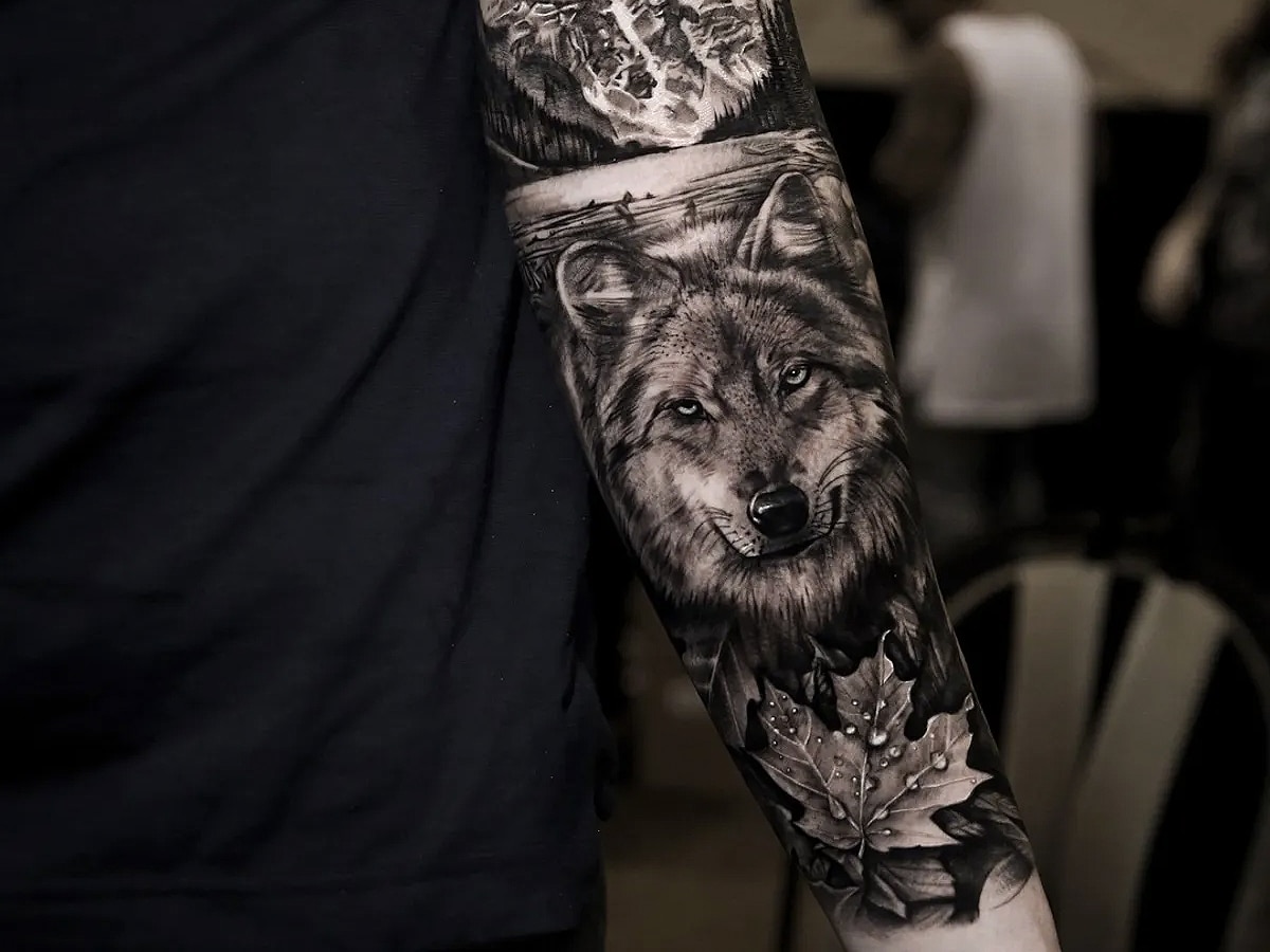 Close up on a wold design black and gray tattoo sleeve