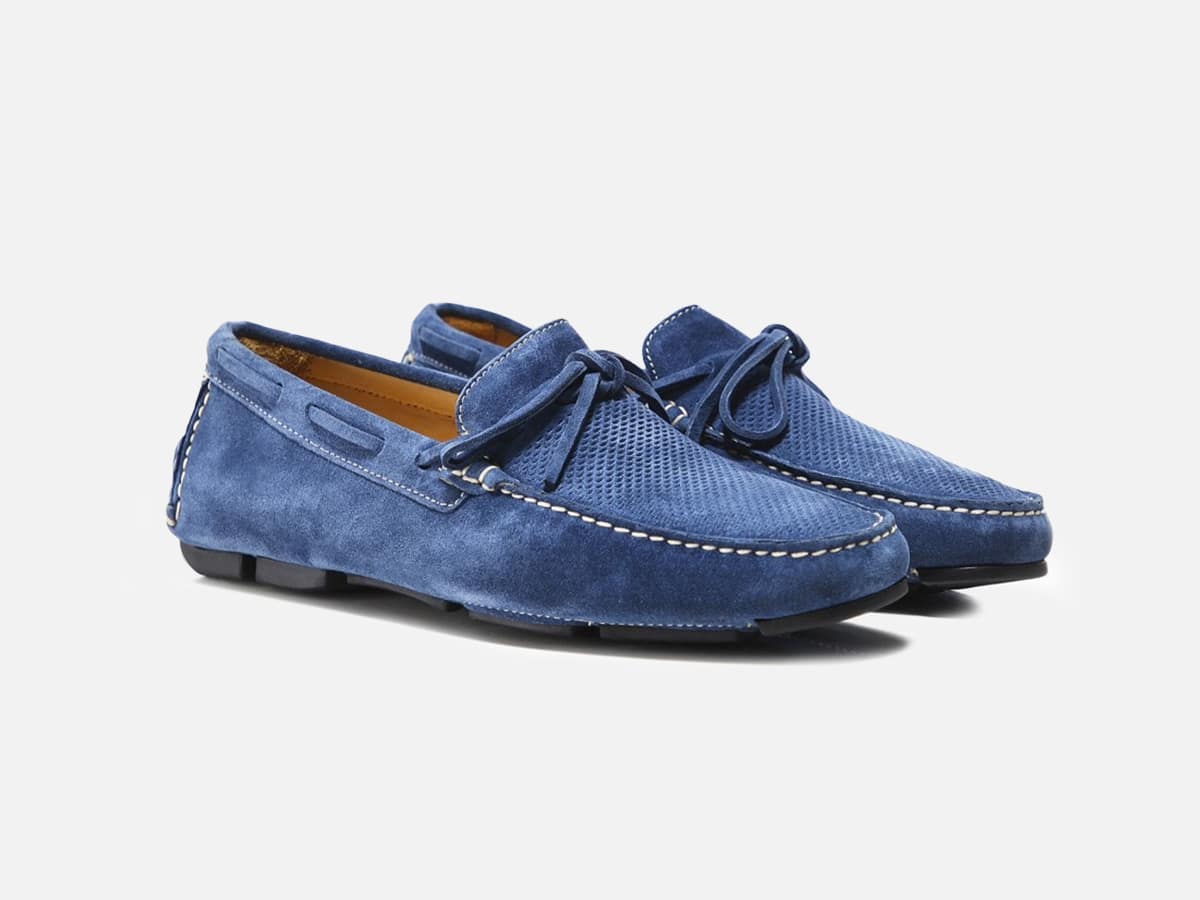 Blue driving loafers with plain white background