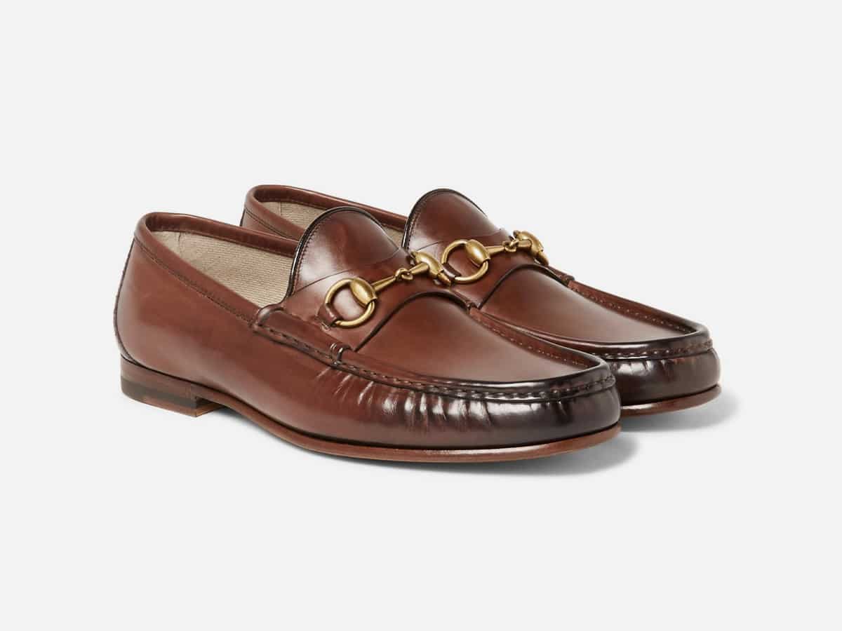 Brown horsebit loafers with plain white background