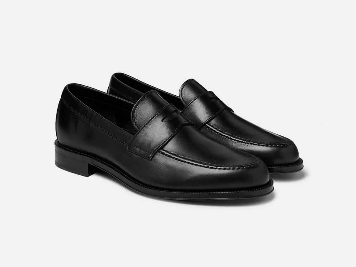 Black penny loafers with plain white background