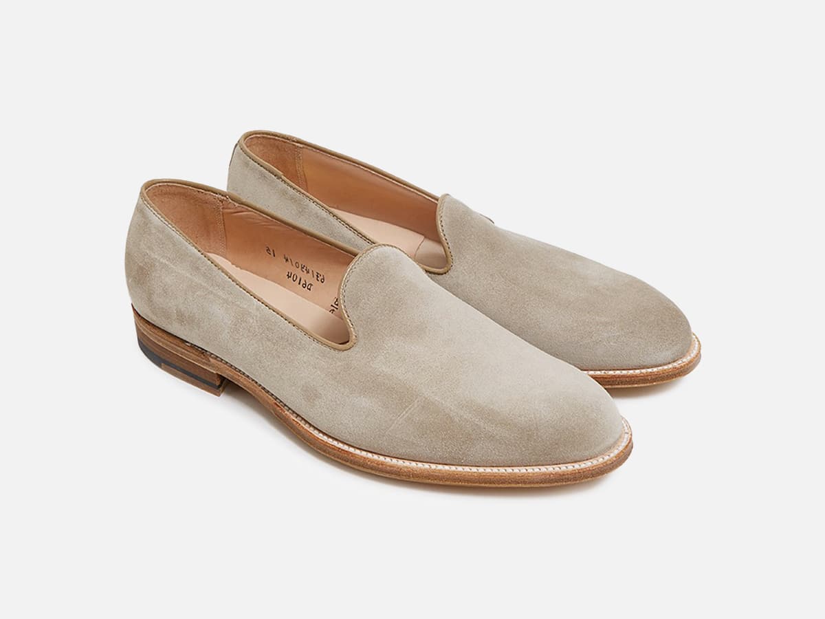 Nude color slipper loafers with plain white background