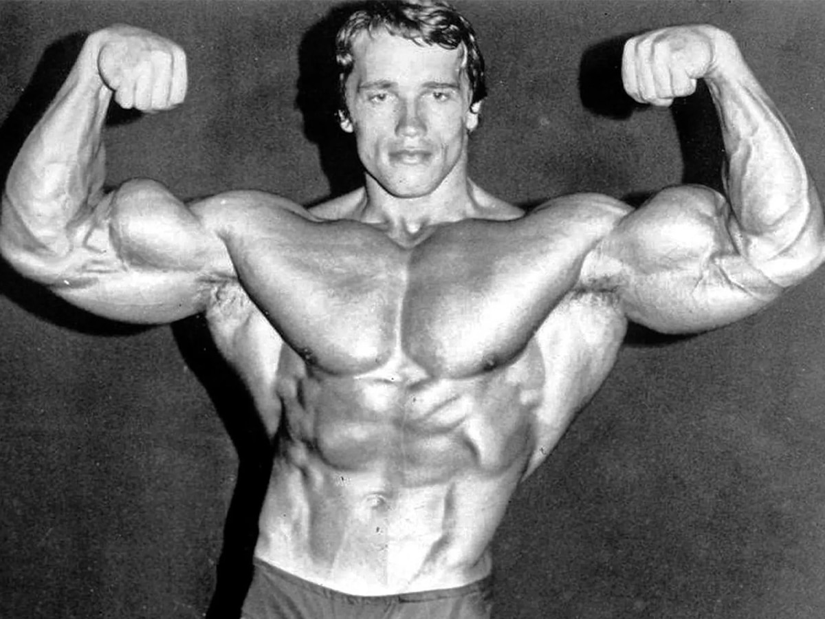 Shirtless Arnold Schwarzenegger flexing his biceps
