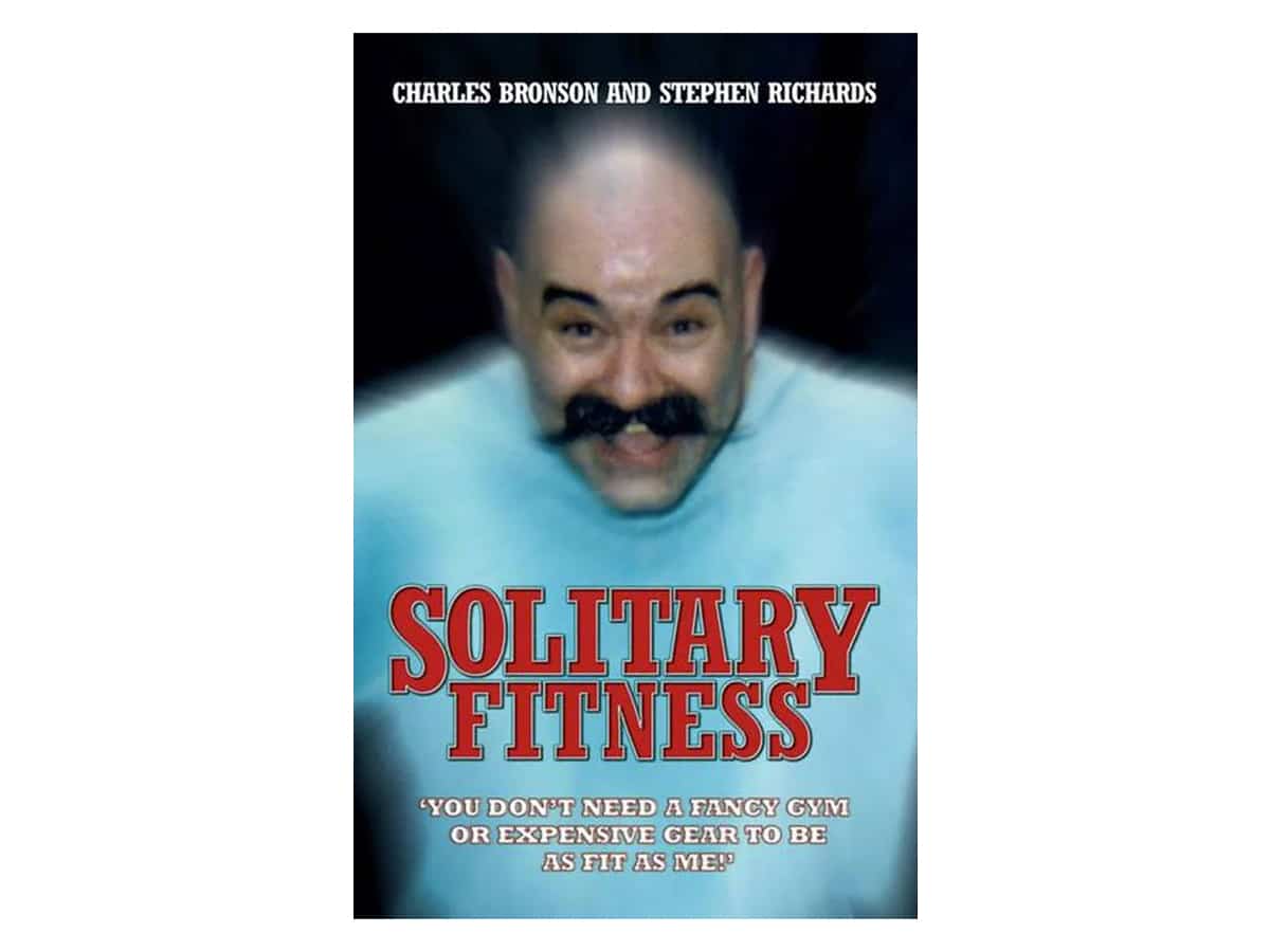 Book cover of Solitary Fitness featuring Charles Bronson laughing