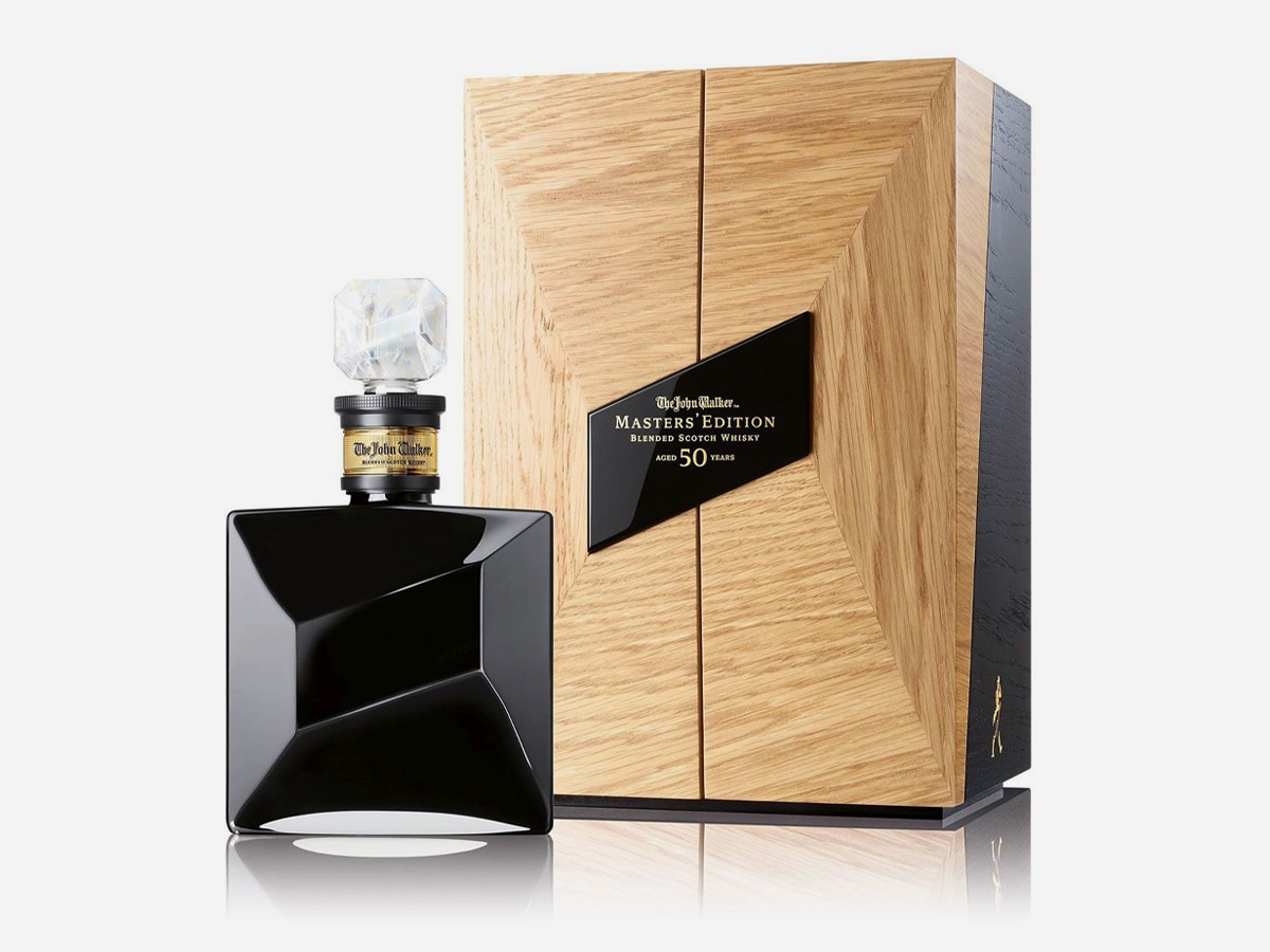 A bottle of premium whisky Johnnie Walker Master’s Edition and its deluxe packaging displayed against a clean white background