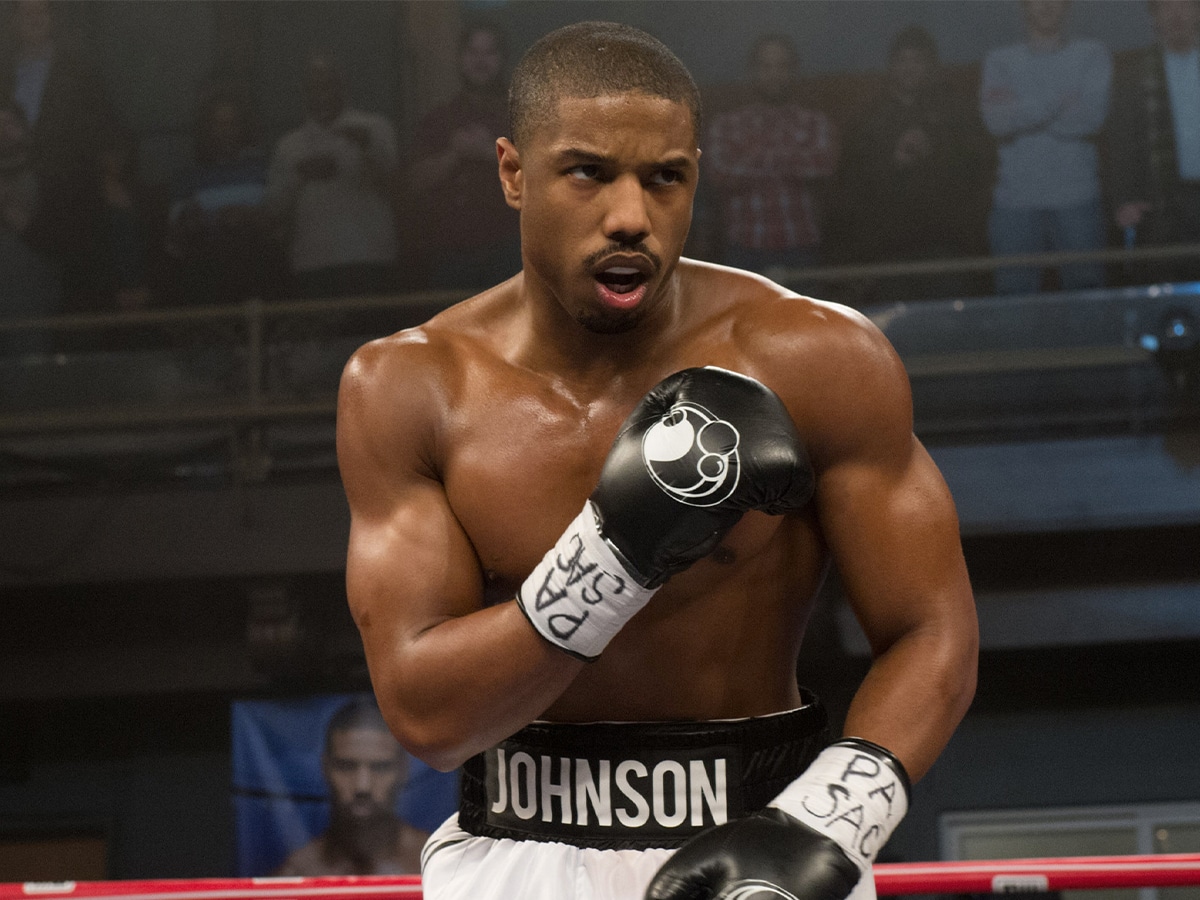 Medium shot of Michael B Jordan with boxing gloves in a defensive stance