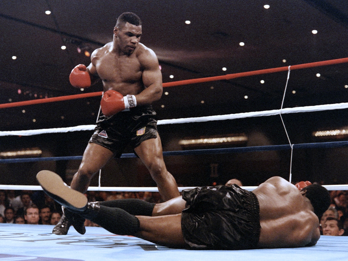 Mike Tyson floors Trevor Berbick in the boxing ring